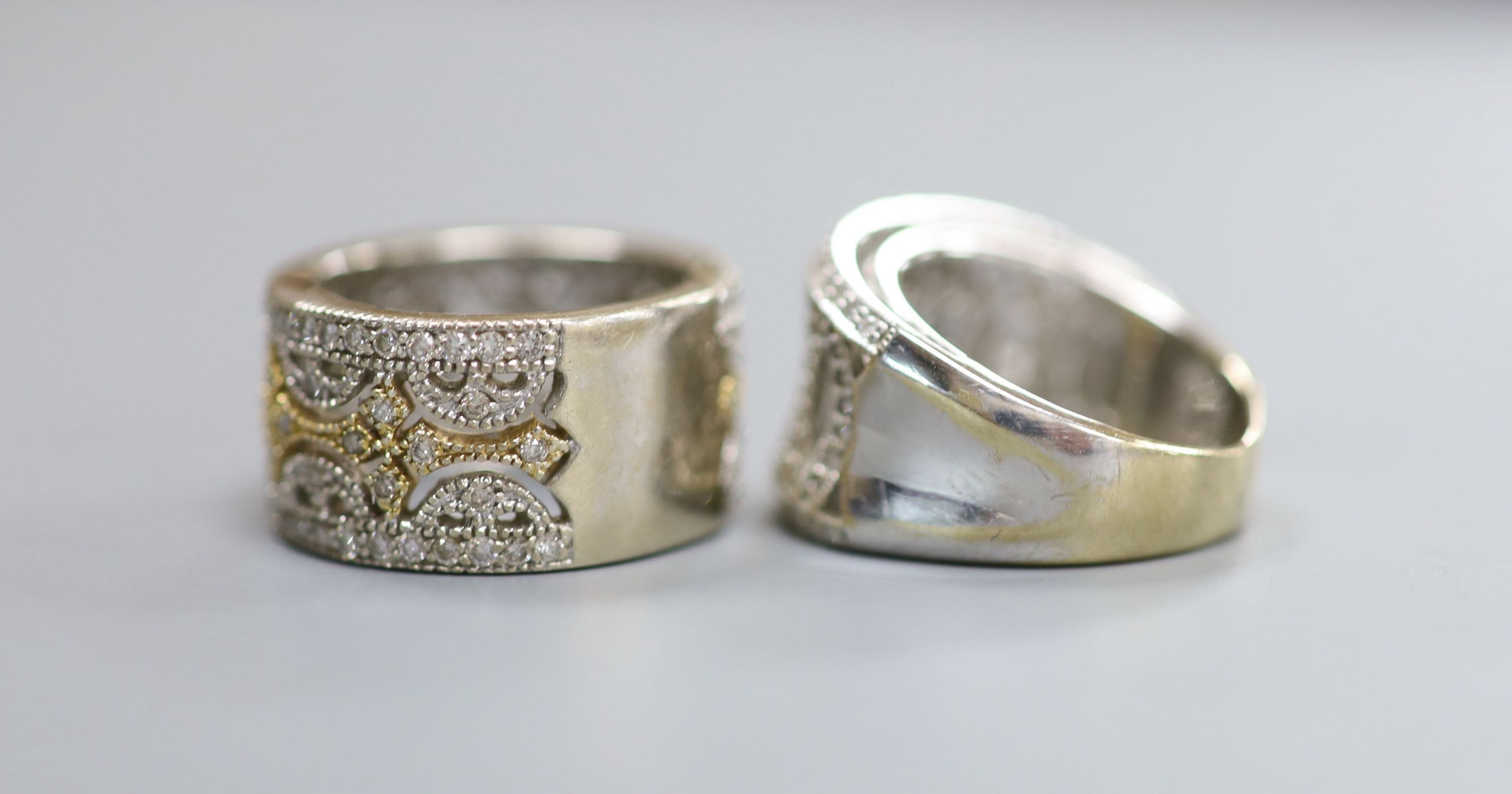 Two modern pierced yellow and white metal, diamond chip cluster rings, sizes K M, gross weight 18.9 grams.